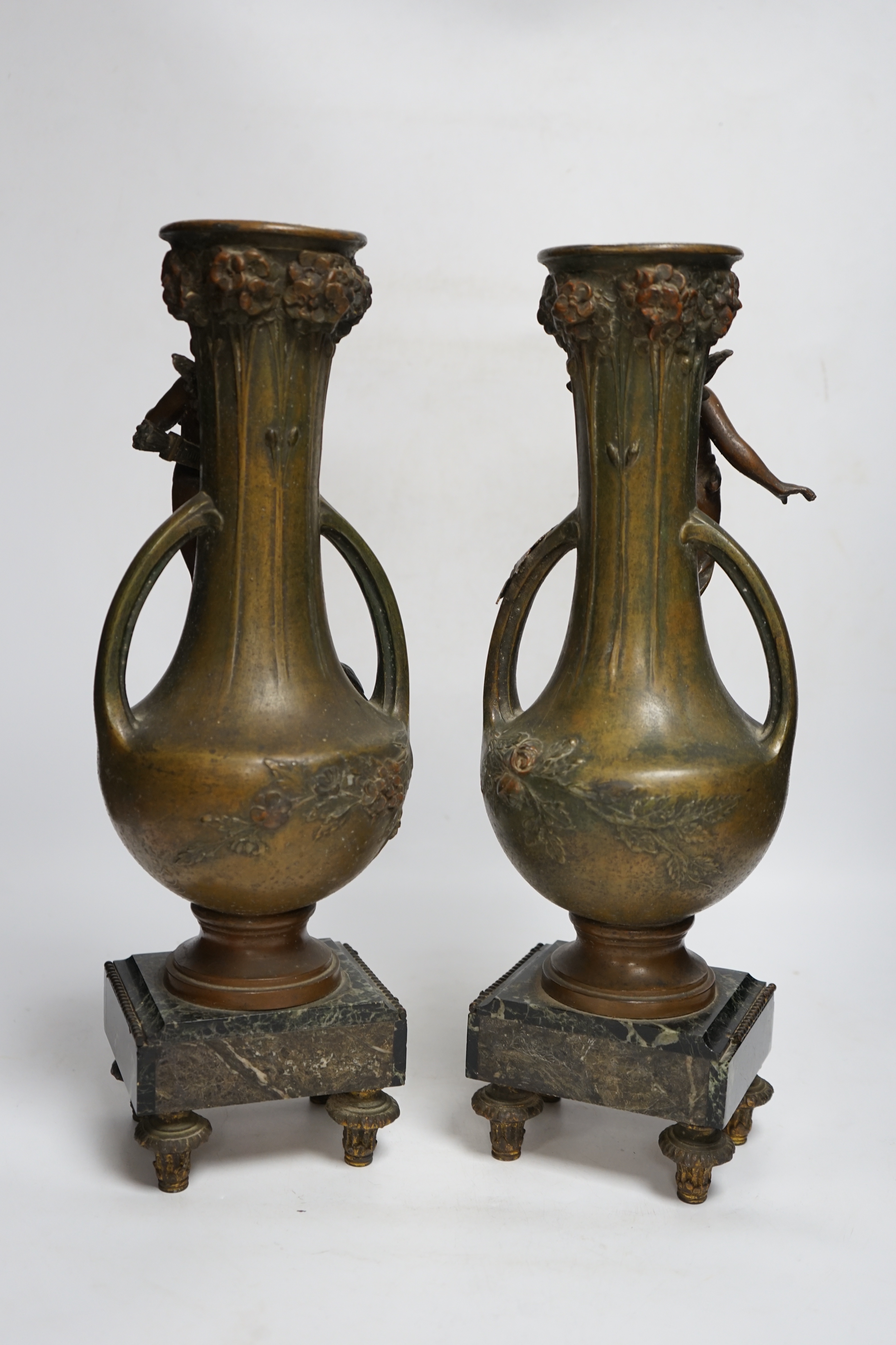 After Hippolyte François-Moreau (1832-1927), a pair of bronzed spelter cherubic vases on marble bases, 42cm